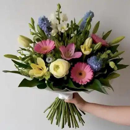 Hand Tied Flower Bouquet with fresh seasonal blooms in vibrant colors.